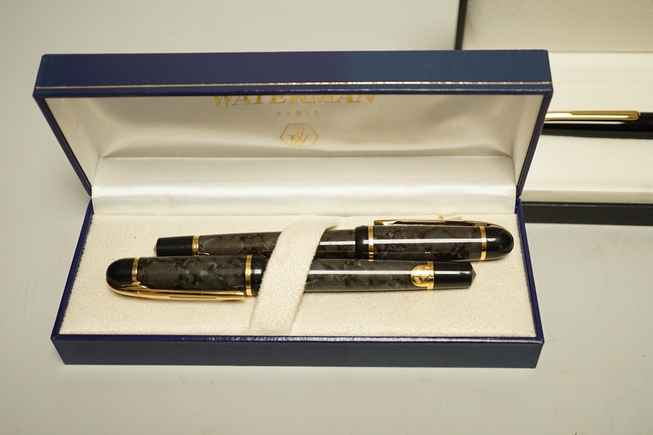 A Watermans marbled fountain pen and ballpoint pen ensuite, cased and a Montblanc ballpoint pen, cased